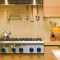 Contemporary Yellow Kitchen With Blue Stove Knobs and Rift Oak Cabinets