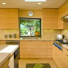 Bright, Beige Kitchen With Bay Window and Green Bird Rug 