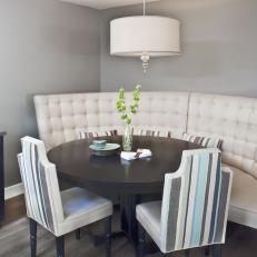 Corner Dining Nook With Tufted Bench and Striped Chairs
