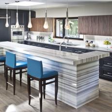 Contemporary Kitchen With Teardrop Pendant Lights and Sleek Striato Marble Island 