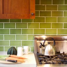 Updated Craftsman-Style Kitchen With Green Backsplash and Stainless Steel Appliances
