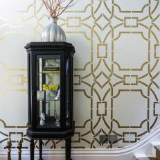 Dramatic Entryway With Metallic Stenciled Wall and Vintage Curio Cabinet