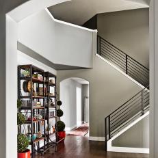 Dramatic Entryway With Industrial-Rustic Bookcases