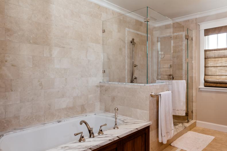 Beige Master Bathroom With Glass-Enclosed Shower and Tub
