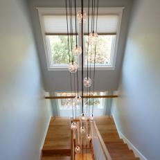 Contemporary Stairwell With Deformed Glass Light Fixture