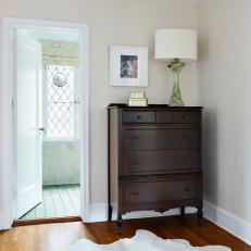 Neutral Transitional Bedroom with Wood Dresser 