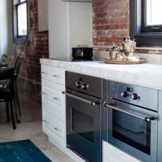 Stainless Steel Ovens and Range Hood in Small Kitchen