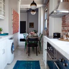 Galley Kitchen With Pendant Lights and Exposed Brick 