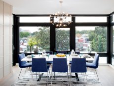 White Modern Dining Room With Blue Chairs, Chandelier, Big Windows