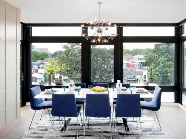 White Modern Dining Room With Blue Chairs, Chandelier, Big Windows