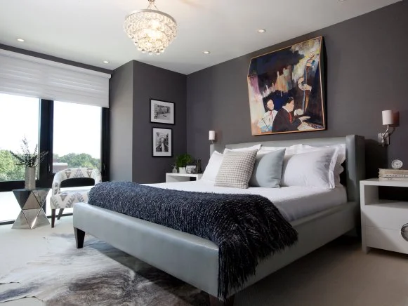 Gray Modern Bedroom With Chandelier and Multicolored Artwork