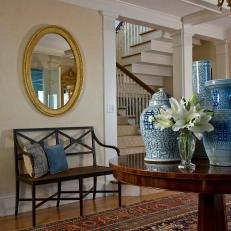Traditional Entryway with Blue Vases and Oval Mirror