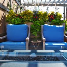 Rooftop Deck With Blue-Cushioned Chairs and Fire Pit