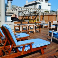 Contemporary Roof Deck With Blue-Cushioned Lounge Chairs