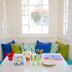 White Breakfast Nook With White Table, Colorful Throw Pillows