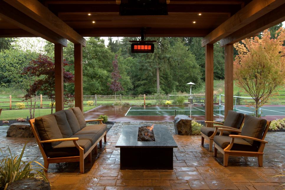Transitional Covered Patio With Seating Area and Fire Pit | HGTV