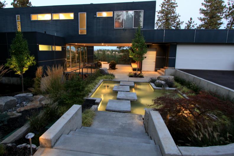 Modern Home Exterior With Pond and Square Concrete Steps