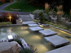 Modern Pond With Square Concrete Steppingstones and Ornamental Grasses