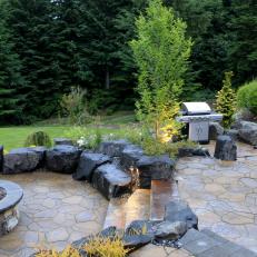 Stone Patio With Fire Pit and Adjacent Outdoor Dining Area