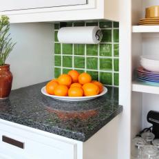 White Kitchen Shelving, Green Tile Backsplash, and Oranges
