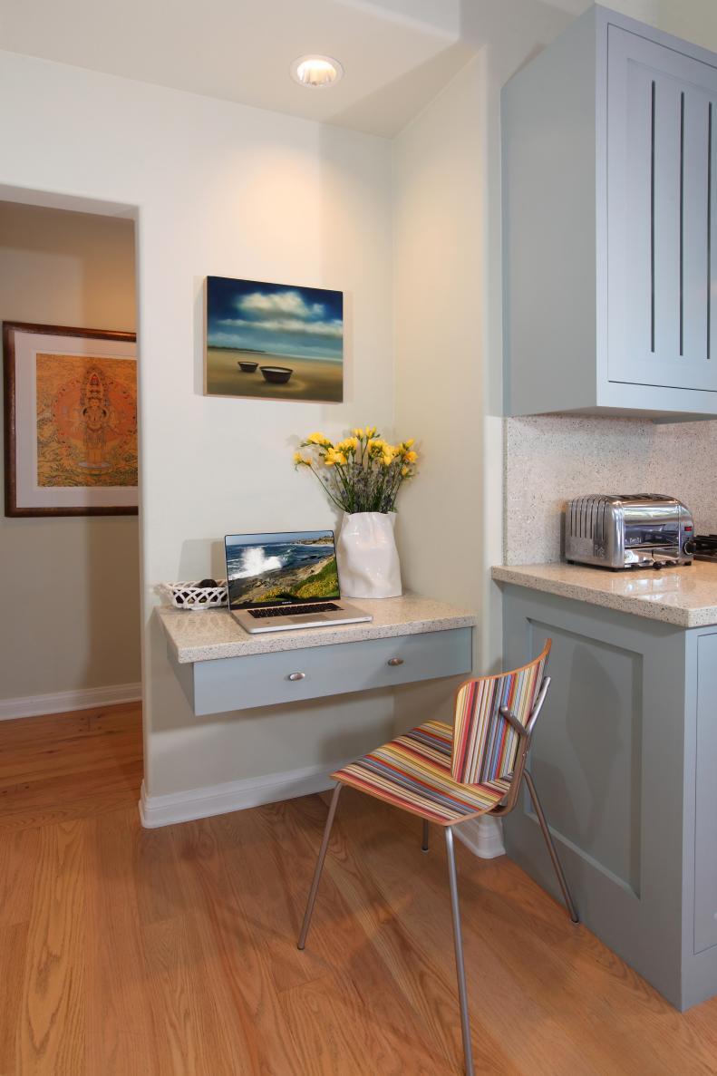 White Kitchen With Floating Desk Drawer and Multicolored Striped Chair