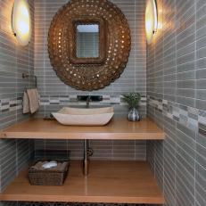 Powder Room With Hand-Carved Stone Sink and Pebble Floor