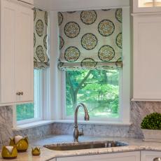 Crisp and Clean Kitchen With Basin Sink and Graphic Roman Shades
