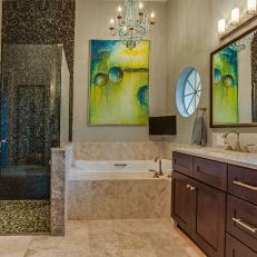 Elegant Master Bathroom With Pebble Shower and Marble Accents