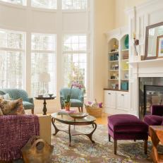 Bright Living Room With Bay Window and Purple Accents