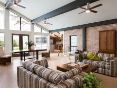 Spacious Modern Living Space With Vaulted Ceiling and Brick Wall