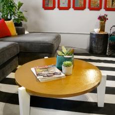 Eclectic Living Room With Striped Rug and Gold Coffee Table