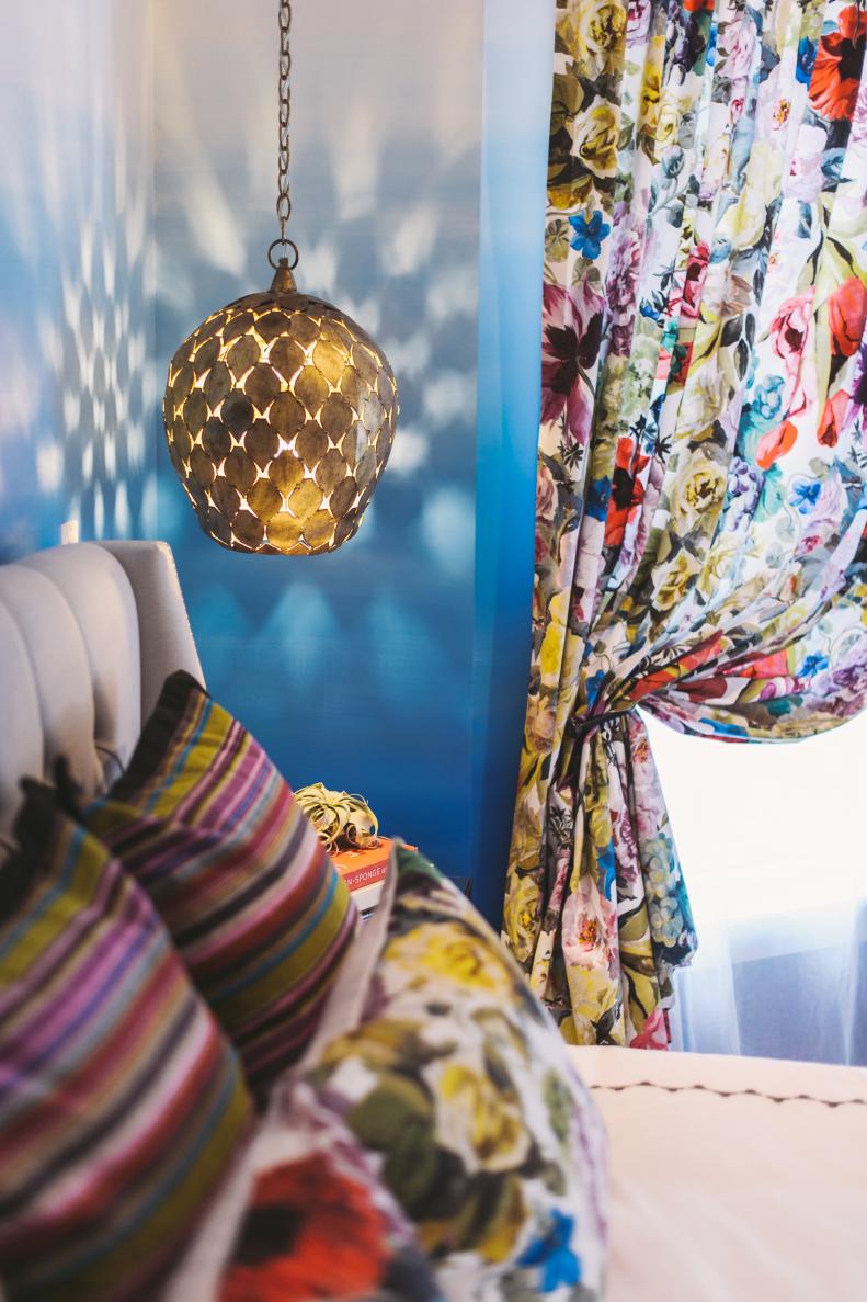 Eclectic Bedroom With Metal Light and Multicolored, Floral Curtains