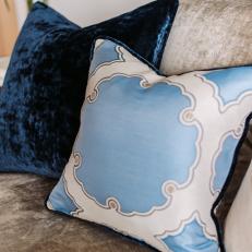 Neutral Velvet Sofa with Blue Throw Pillows