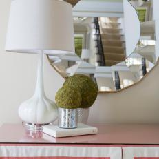 White Lamp in Front of Round Mirror