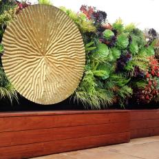 Stylish Vertical Garden With Large Metal Medallion