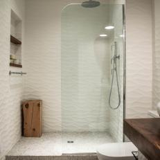 Walk-In Shower With Rippled Tile Walls and Glass Wall