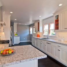 Timeless White Galley Kitchen With Bold Orange Accents