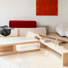Modern Living Room with Wood Plank Table and Bold Red Art