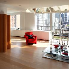 Modern Living Area With Red Accents and Stunning Skyline View