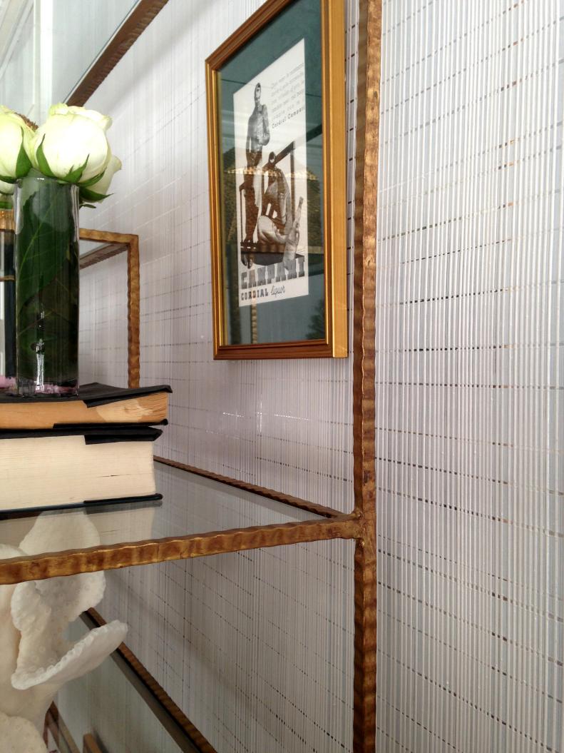 Gold Bookshelf Against White Textured Wallpaper