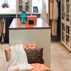 Elegant Walk-In Closet With Salmon Tufted Chair