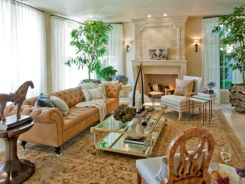Neutral Mediterranean Living Room With Stone Fireplace and Tan Sofa