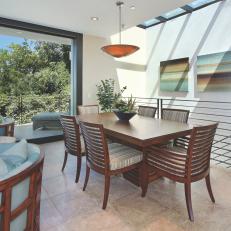 Dining Room with Skylight, Wood Dining Table and Stone Floor