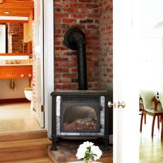 Indoor Wood Stove with Red Brick Wall
