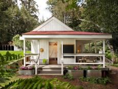 White Country Home Exterior With Porch and Container Garden