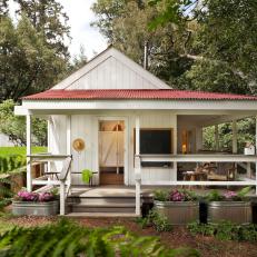 White Country Home Exterior With Porch and Container Garden