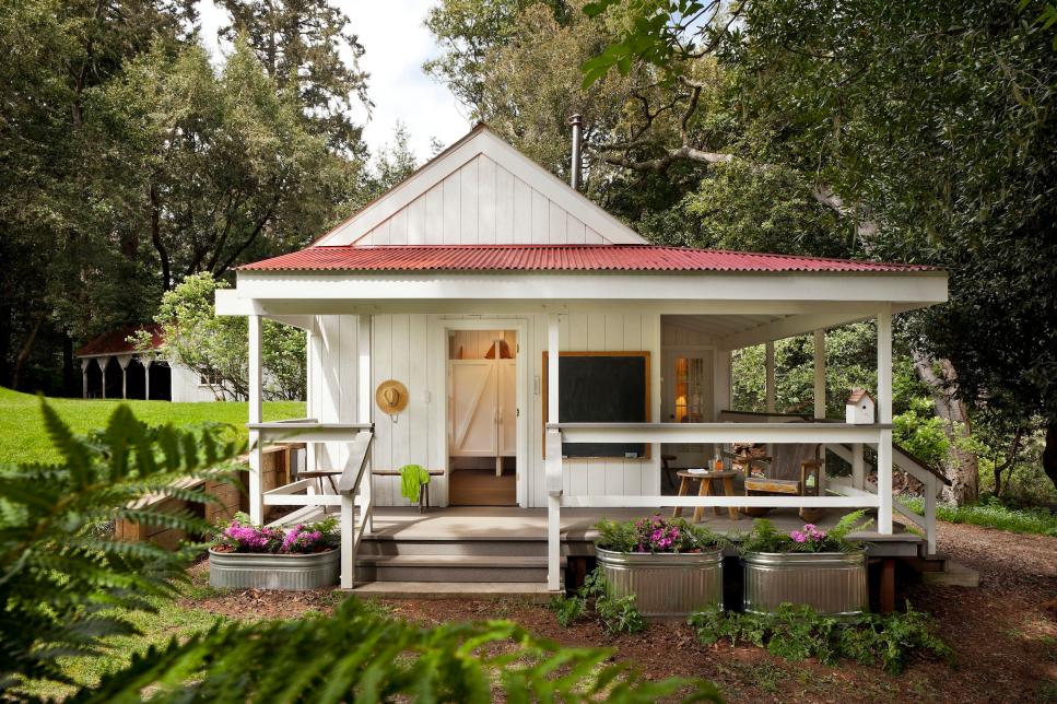 White Country-Style Home Exterior With Porch and Container Garden
