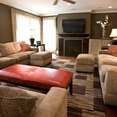 Burnt Orange Accents Pop in Brown Living Room