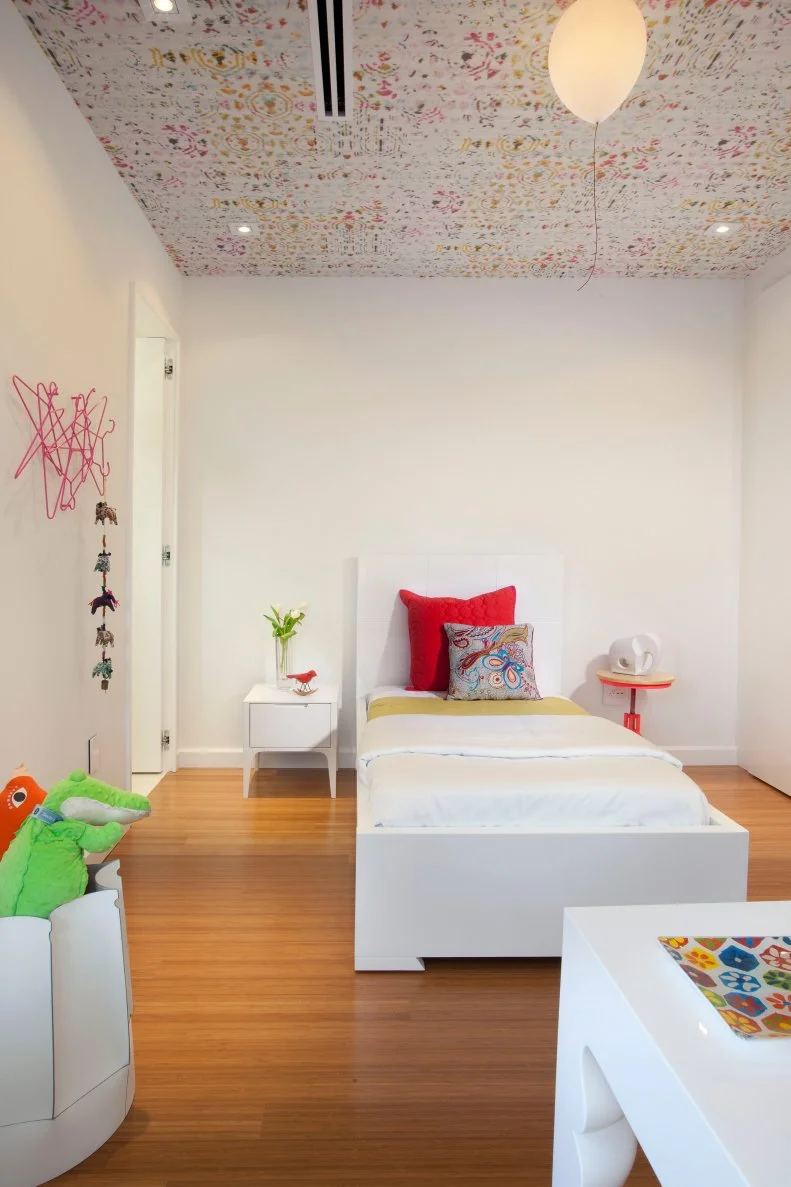 Whimsical accents in a white, modern kids bedroom