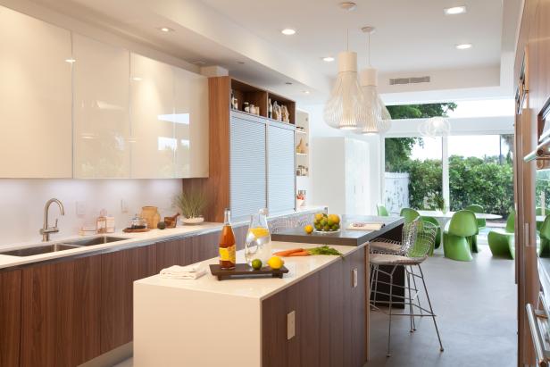 Eat-In Kitchen With White Cabinets, Brown Cabinets and Green Chairs